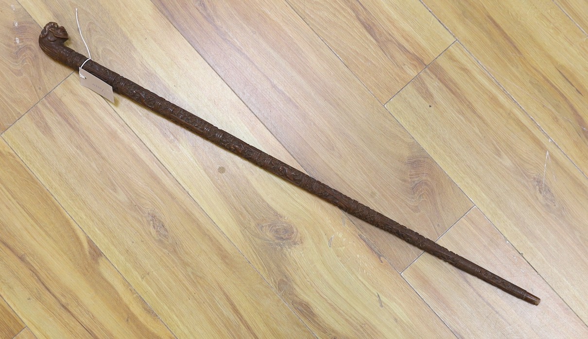 An Asian carved wood walking cane, 7 cm long.